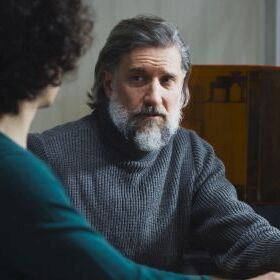 An older employee talks to a younger one