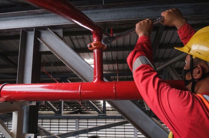 Fitter with red suit and yellow helmet