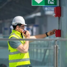 Fitter with yellow vest and helmet